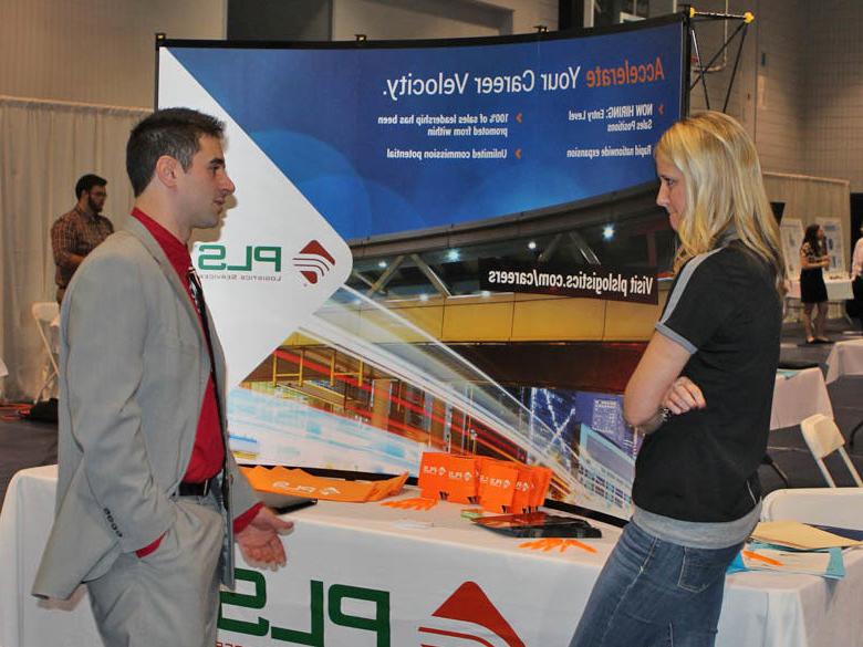 Male student talks to an employer at the Career Fair